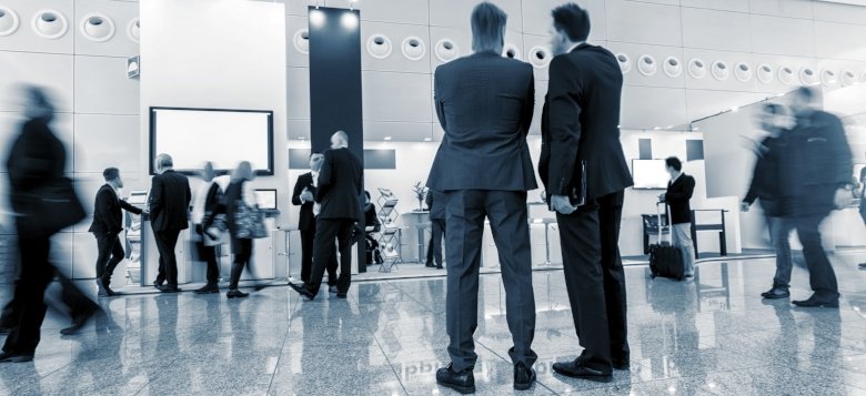Men in suits at trade show
